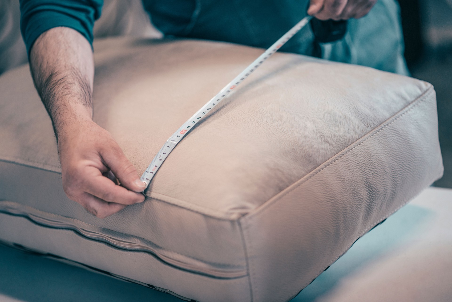 Upholstery Worker Measuring Width Of Pillow